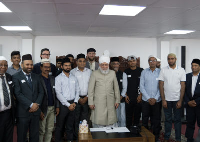 Group picture during the new converts mulakat with Huzoor (may Allah be His helper)