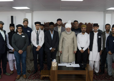 Group picture during the new converts mulakat with Huzoor (may Allah be His helper)